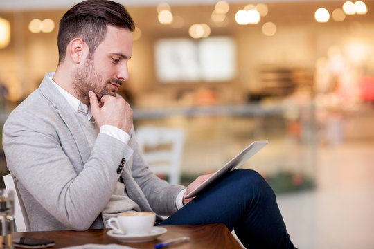 young businessman working on a digital tablet in a cafe