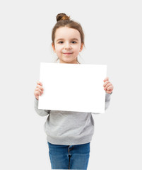 Girl holding a white plate on a gray background