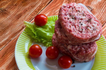 Raw cutlets, tomatoes - ready for cooking, top view