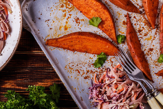 Homemade cooked sweet potatoes with coleslaw.