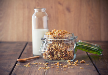 Healthy Breakfast - milk with homemade granola on the bright wooden board