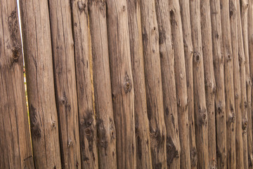 closeup old wooden fence of logs in form of palisade
