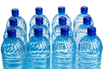 Closeup on rows of refreshing natural mineral water in plastic bottle in white background