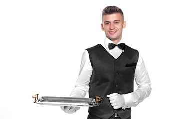 Portrait of young happy smiling waiter with on tray isolated on