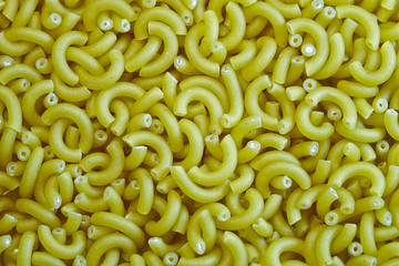 Pasta  tube texture background. Pasta is a staple food of traditional Italian cuisine. Closeup.