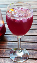 A glass filled with ice and sangria.
