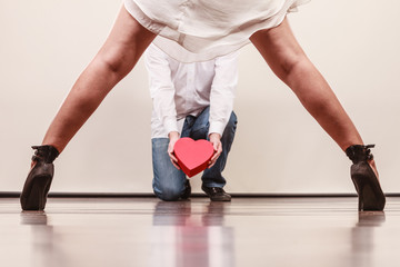 Man with heart shaped gift box for woman.