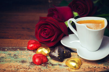 Obraz na płótnie Canvas Valentine's day celebration with heart chocolate, coffee cup and roses on wooden background