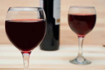 Fotobehang Two glasses of wine on  wooden background © Luba Shushpanova