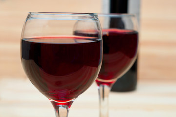 Two glasses of wine on  wooden background