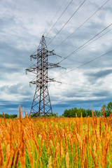 High voltage line and cloudy sky