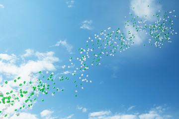 green and white balloons in the sky