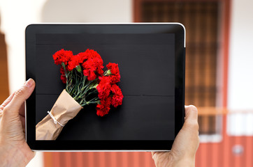 Hands holding tablet with sign valentines day