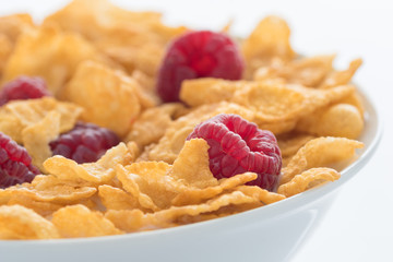 Himbeeren und Cornflakes in einer weißen Schüssel