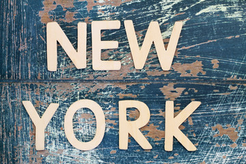 New York written with wooden letters on rustic surface
