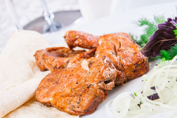 Grilled pork on white plate