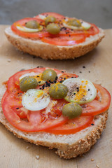 Healthy sandwich made with soy rolls with tomato, onions, green olives and spices.
