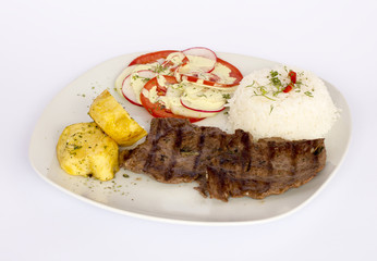 Grilled beef fillet assorted peruvian dish, rice, potatoes, tomatoes, 