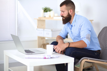 Young businessman sitting on chair in office