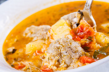 Traditional armenian soup kololik. Tomato soup with meatballs and rice