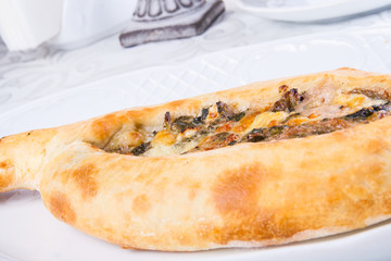 Adjarian khachapuri with cheese and spinach