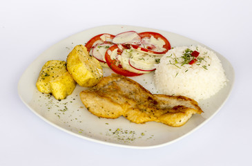 Grilled fish and vegetables, potatoes, rice, tomatoes and chicha morada.