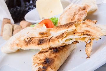 Roasted rolls of bread lavash filled with cheese and herbs