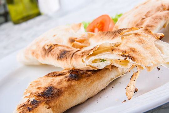 Roasted rolls of bread lavash filled with cheese and herbs