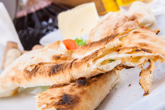 Roasted rolls of bread lavash filled with cheese and herbs