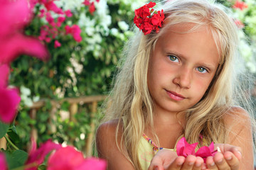 Little girl with flower in her hands