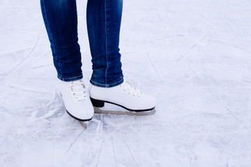 Woman ice skating. winter outdoors on ice rink.