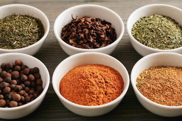 Colored spices in white ceramic bowls
