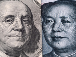 US dollar bill (Ben Franklin) and Chinese yuan banknote (Mao Zedong) close up macro, united states and China money closeup