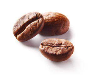 Image of roasted coffee beans over white background
