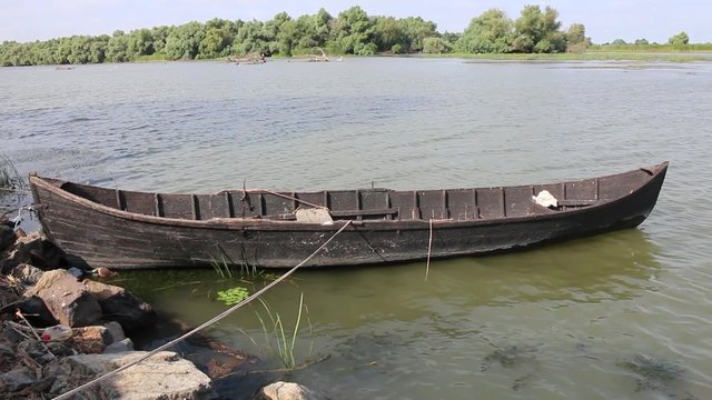 Old wooden boat moored in the river