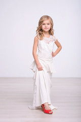 Cute little girl standing in  a wedding dress