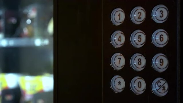 Person picking out item from vending machine.