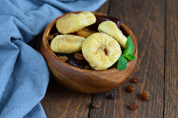 Dried Figs in a bowl on wooden background
