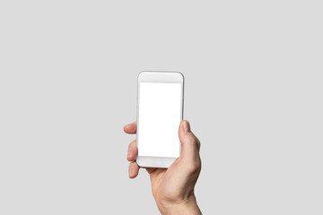 Hand holding modern smartphone in front of isolated background and blank touch screen