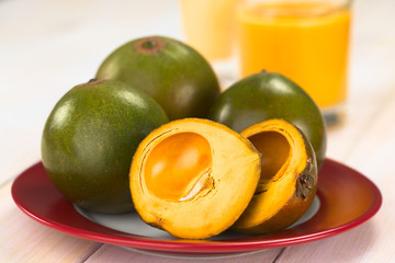 Peruvian fruit called Lucuma (lat. Pouteria lucuma), which has a dry, sweet flesh (Selective Focus, Focus on the front of the first fruit)