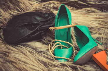 Fashion setup: handbag, heels and pearls.