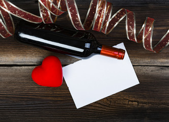 Red Wax Heart, Sheet Of Paper, Bottle Red Wine And Beautiful Ribbon On Old Wooden Boards. Romantic Composition.