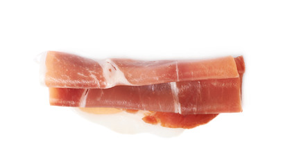 Folded prosciutto ham slice isolated