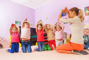 Playing game and group of kids show home with hand