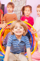 Close portrait of a boy playing with other kids