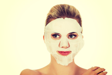 Young happy woman with facial mask.