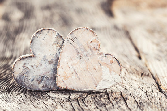 Valentines Day background. Two hearts on wooden background. Toned, selective focus