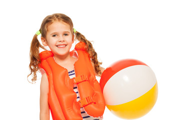 Fototapeta na wymiar Smiling girl in lifejacket with colored wind-ball