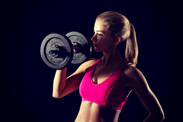 Young sweat woman woman lifting dumbbells