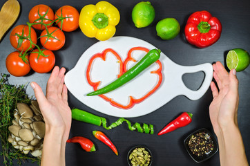Woman hand and white cutting board framed the vegetables
